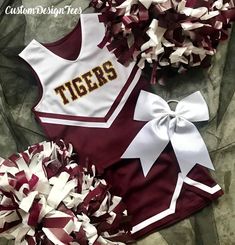 two cheerleader outfits with bows on them