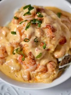 seafood stuffed potatoes with gravy in a white bowl
