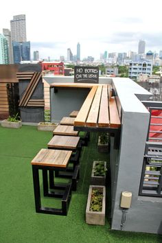 a wooden bench sitting on top of a green roof