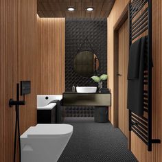 a modern bathroom with wood paneling and black flooring, along with a white toilet and sink