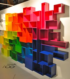 colorful bookshelves are arranged on the wall