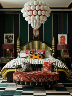 a bedroom with black and white checkered flooring, green walls and a large chandelier above the bed
