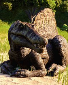 a large dinosaur sitting in the grass next to a tree