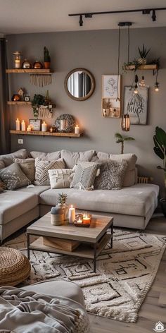 a living room filled with lots of furniture and candles on top of it's tables