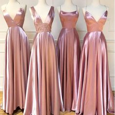 three bridesmaid dresses are lined up on mannequins