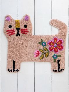 a pink rug with a cat design on the front and back of it's face