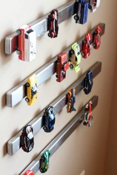 several toy cars are hanging on the wall