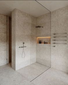 a walk in shower sitting inside of a bathroom