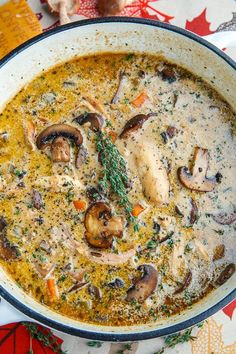 a bowl of soup with mushrooms, carrots and parsley