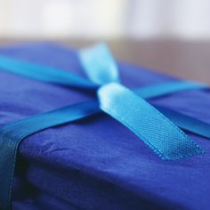 a blue wrapped gift with a ribbon on it