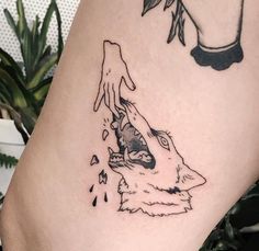 a black and white tattoo of a wolf biting another wolf's head with its mouth