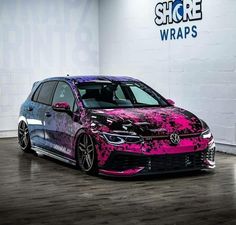 a purple and black car with pink paint on it