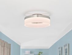 a white ceiling light in a blue room