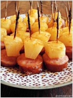 pineapples and meat on skewers with toothpicks in the middle
