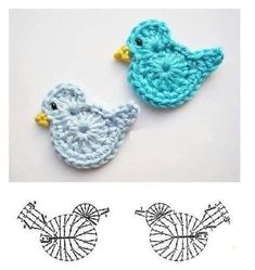 two crocheted birds sitting next to each other