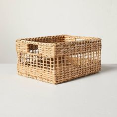 a wicker basket sitting on top of a white table