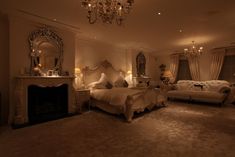 a fancy bedroom with chandelier, couch and bed