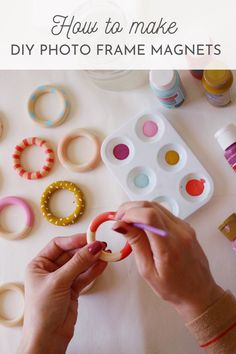 a person is making some crafts with craft supplies on the table and text overlay reads how to make diy photo frame magnets