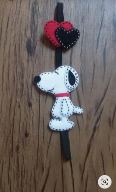 a pair of headphones with a snoopy dog and heart on the earbands