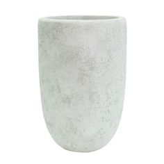 a white vase sitting on top of a table