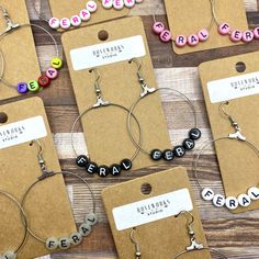 several pairs of hoop earrings with name charms