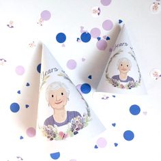 two party hats with the faces of an elderly man and woman on them