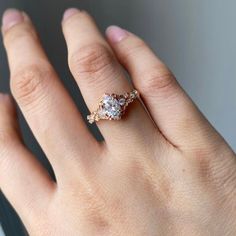 a woman's hand with a three stone ring on top of her left hand