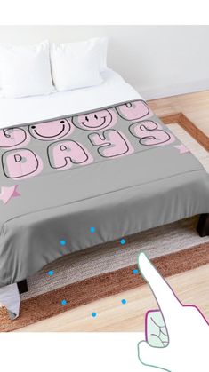 the bed is made up with pink and grey sheets, pillows and pillowcases