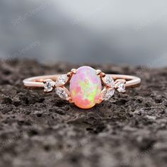 ITEM DESCRIPTION This ring is special for occasion as a gift for girlfriend and wife as anniversary gift, birthday gift, Mother's Day Gift, souvenir present. *Material: Sterling Silver 925 with Rose Gold Plated *Shank width: approx 1.5mm(bottom) *Center Stone: 0.5 Carat, 7X5mm Oval Cut Pink Fire Lab Opal *Accent Stone: Cubic Zircon *Prong Setting The stones of the ring can be replace with other different kinds of gemstone such as aquamarine, amethyst, citrine, white CZ, lab ruby, Sapphire etc. I Black Opal Engagement Ring, Fire Opal Engagement Ring, Opal Promise Ring, Opal Wedding Ring, Pink Opal Ring, Opal Ring Vintage, Opal Engagement Ring Set, Pink Fire, Opal Wedding