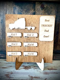 a wooden plaque with the words best truckin'dad ever written in white on it