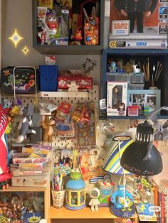a cluttered desk with lots of toys and books on it's shelfs