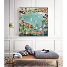 a painting hanging on the wall next to a bed with pillows and a lamp in front of it