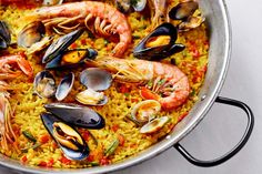 a large pan filled with seafood and rice