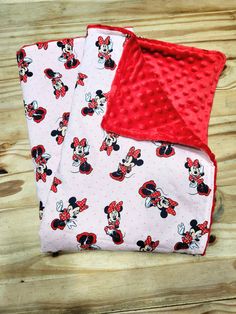 two mickey mouse baby swaddles laying on top of each other with red polka dots