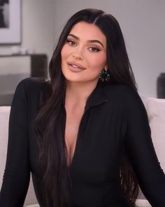 a woman sitting on top of a white couch