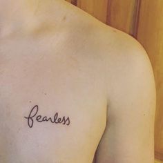 a man's chest with the word fearless tattooed on his left side ribcage