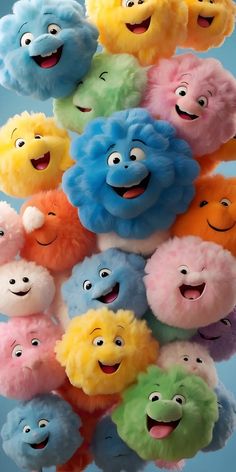 a bunch of stuffed animals that are in the shape of faces on a blue background