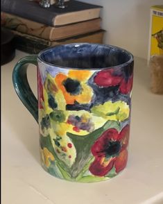 a painted mug sitting on top of a table