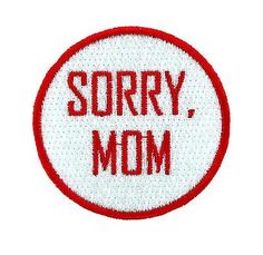 a red and white patch with the words sorry, mom on it's side