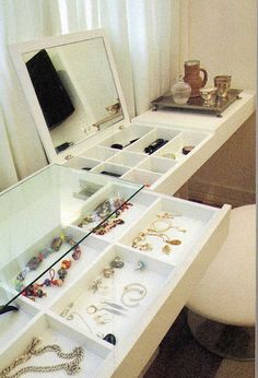 an image of a white vanity with jewelry on it