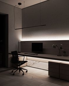 an office with a desk, chair and television on the wall in front of it