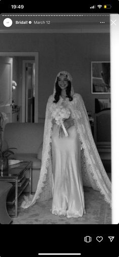 a black and white photo of a woman in a wedding dress with a cape over her head