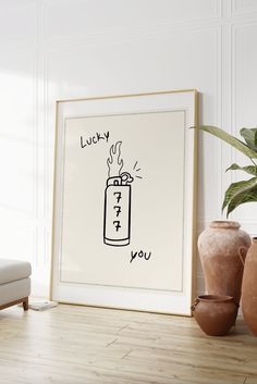 a framed art print with the words lucky written in red on it next to two vases