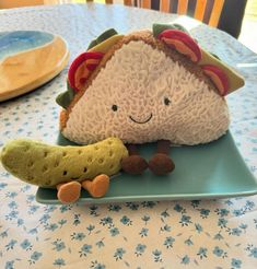 a stuffed animal sitting on top of a green plate