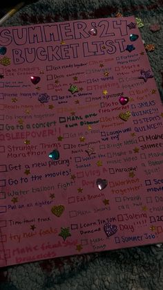 a pink bulletin board with lots of writing on it and confetti around the edges