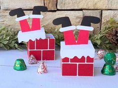 two boxes made to look like santas on top of a brick wall with candy