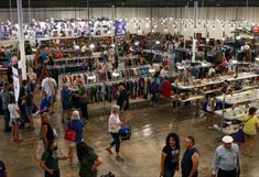 an overhead view of people shopping in a store with lots of lights hanging from the ceiling