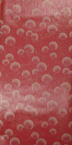 red and gold wallpaper with shells on it