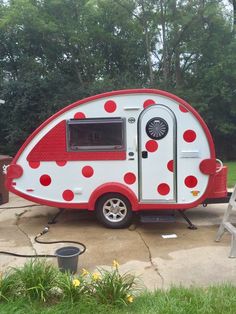 a red and white polka dot trailer parked on the side of a road