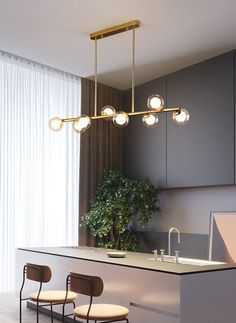 an image of a kitchen with lights hanging from the ceiling and chairs on the counter